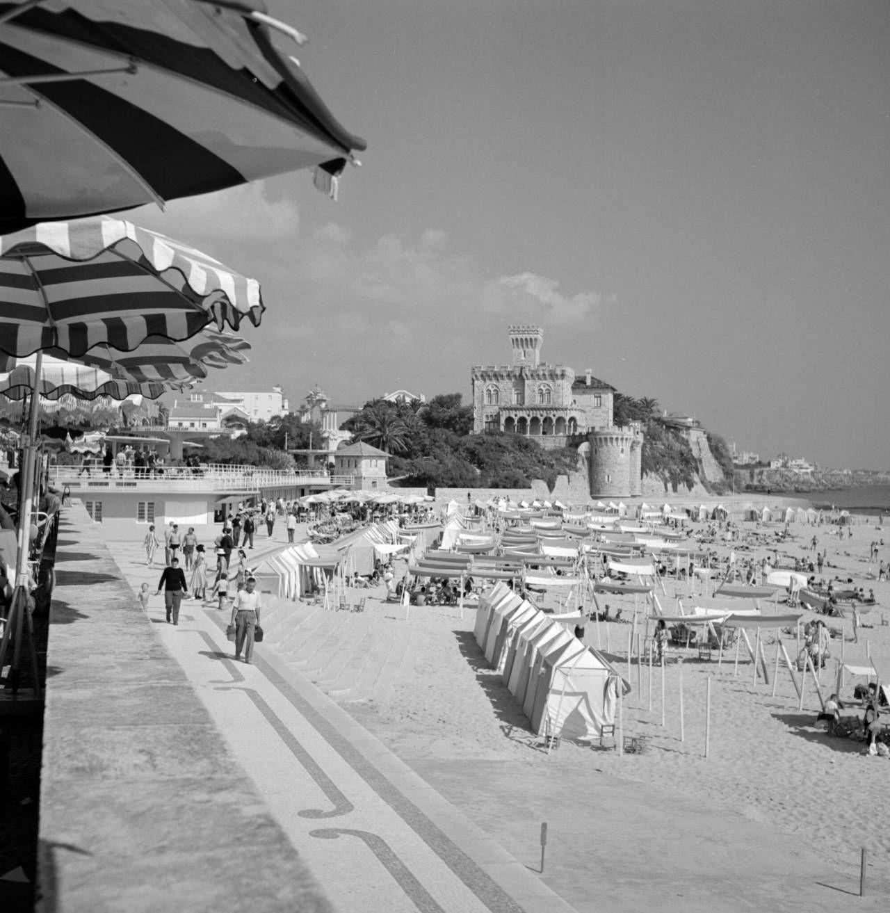 Striped parasols and beach tents along Tamariz beach in the 1960s