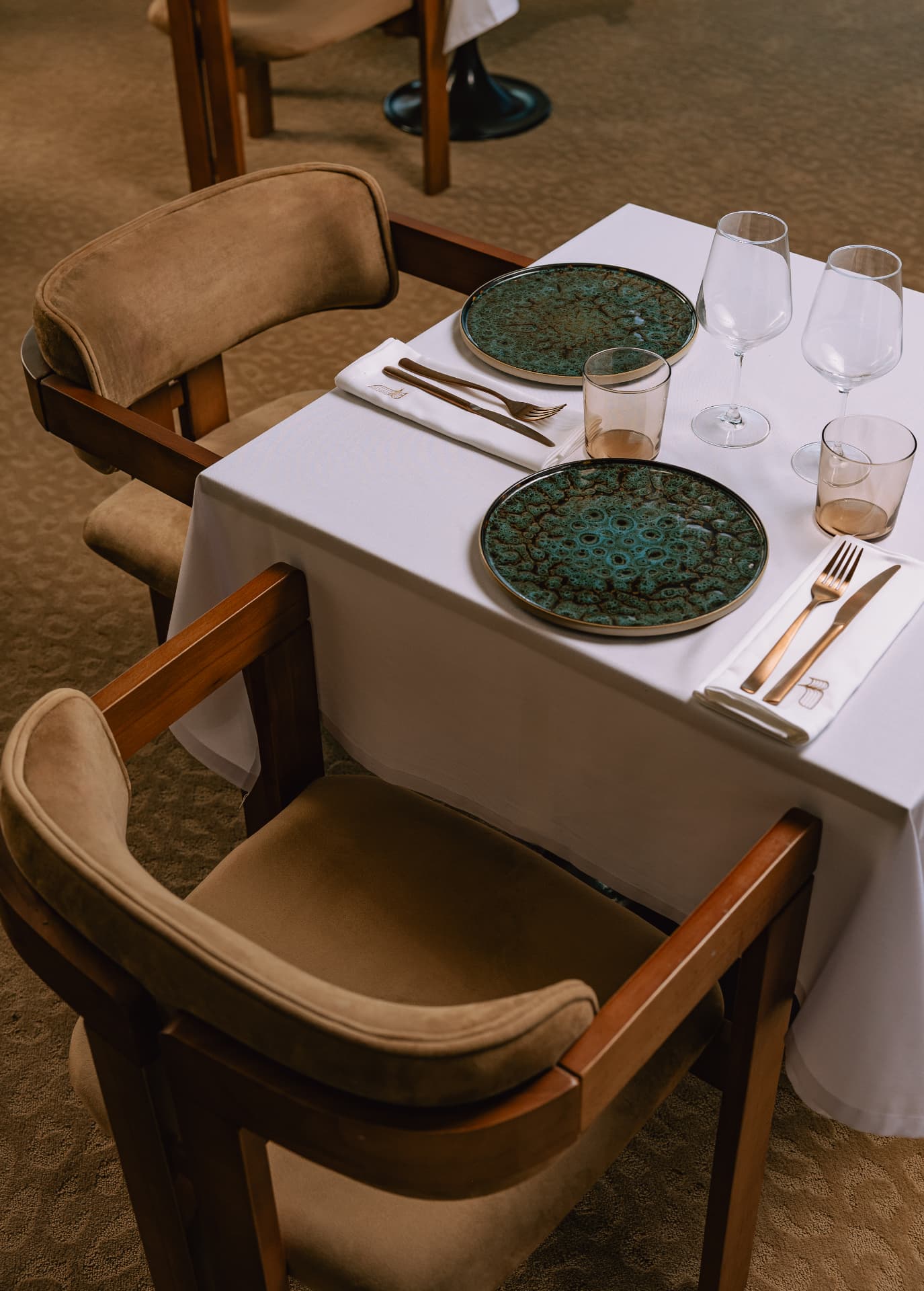 Main Restaurant — table setting with artisanal green ceramics