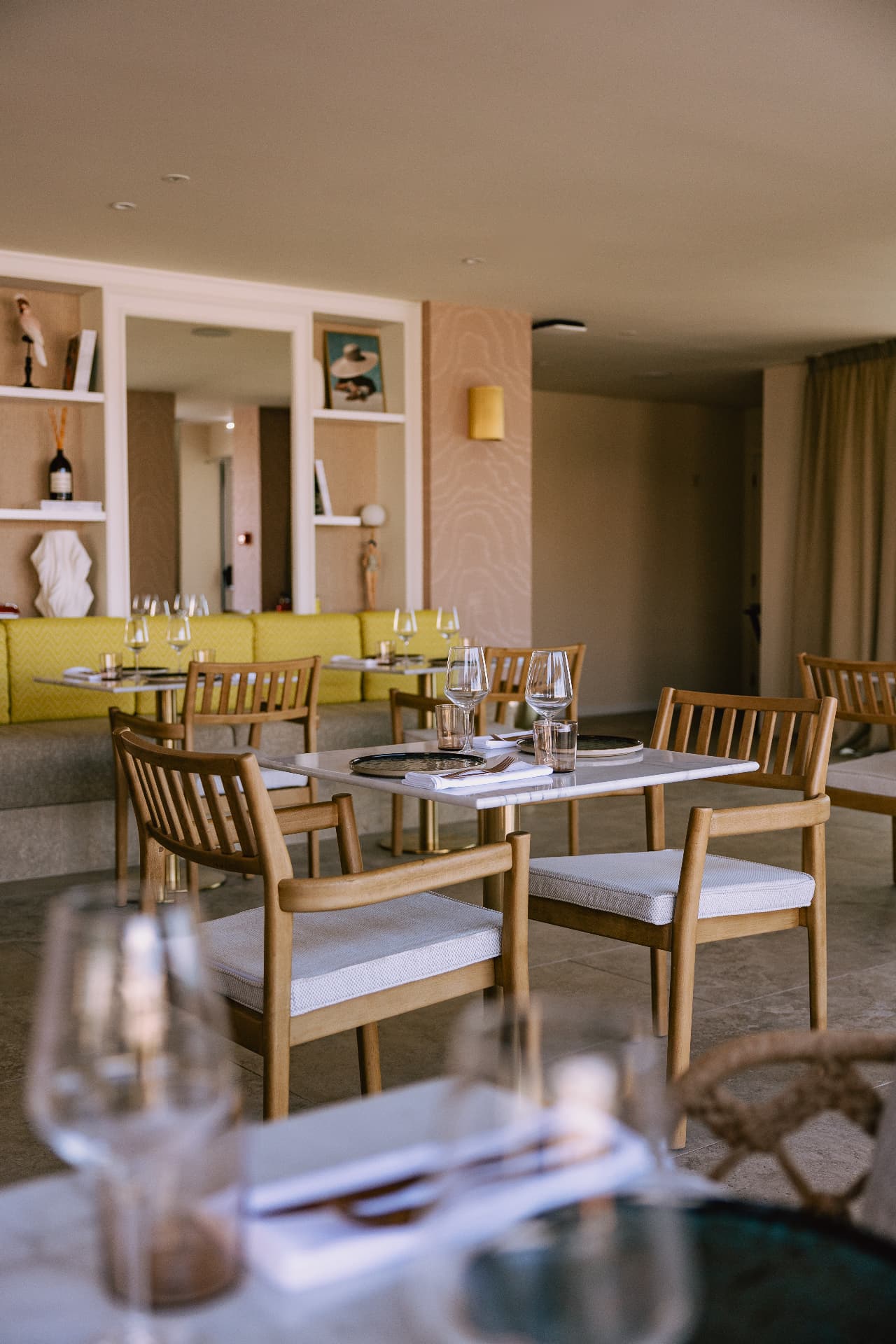 Pool Restaurant — table setting with wooden chairs and soft natural light